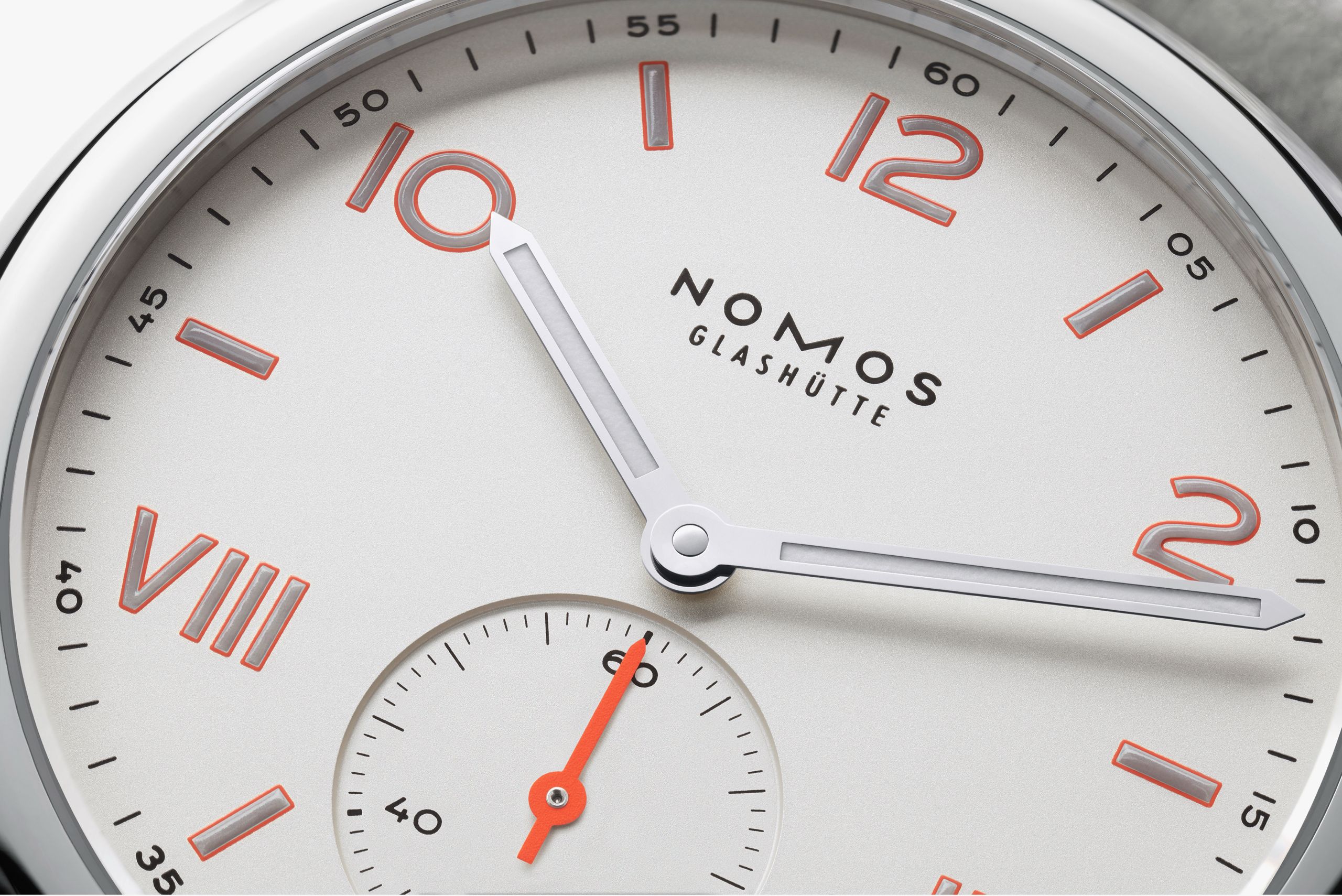 Nomos Glashütte watch with white face and red accents