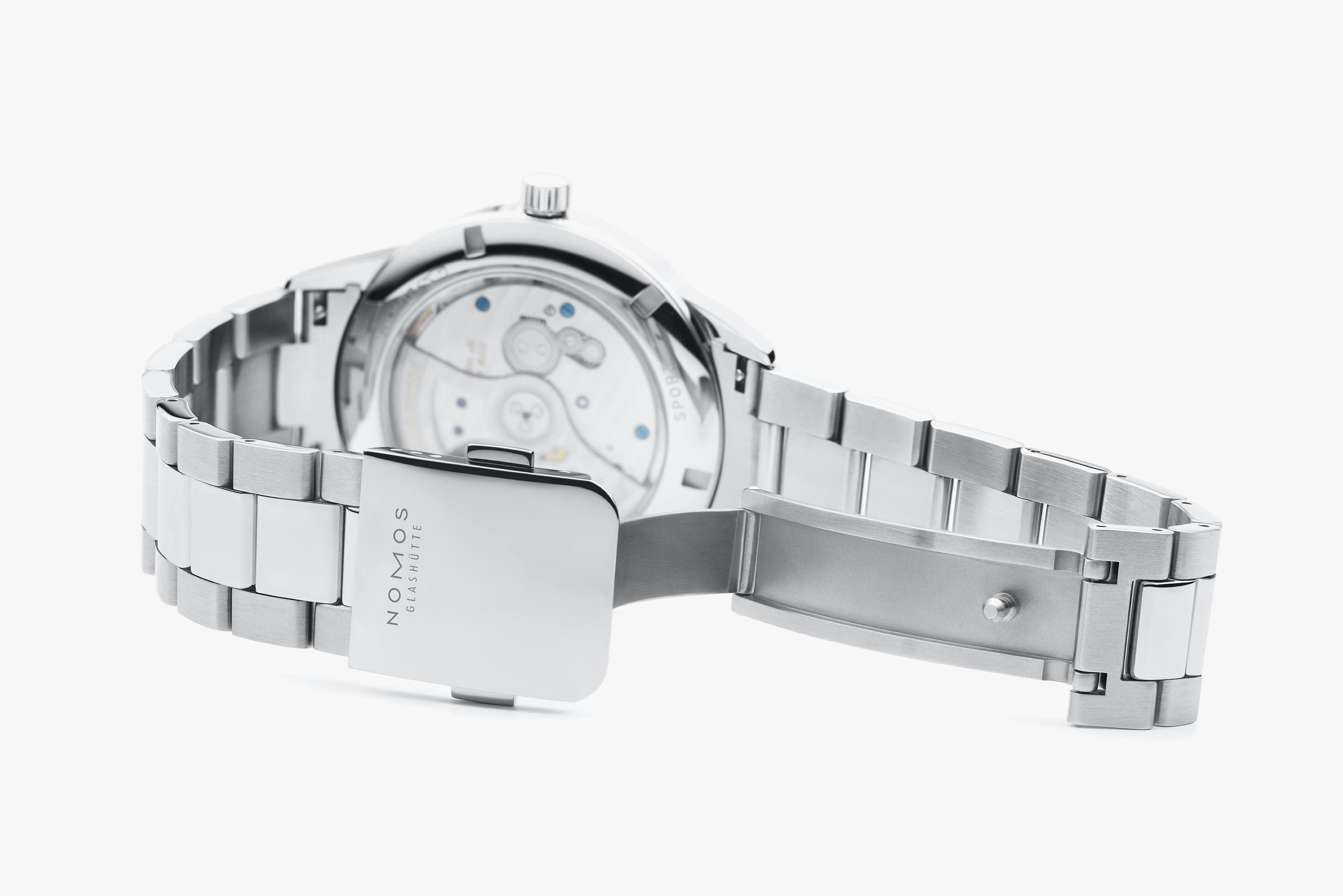 Silver stainless steel automatic watch shown from the back, featuring a transparent case back that reveals the mechanical movement and a matching metal link bracelet with a rectangular clasp.