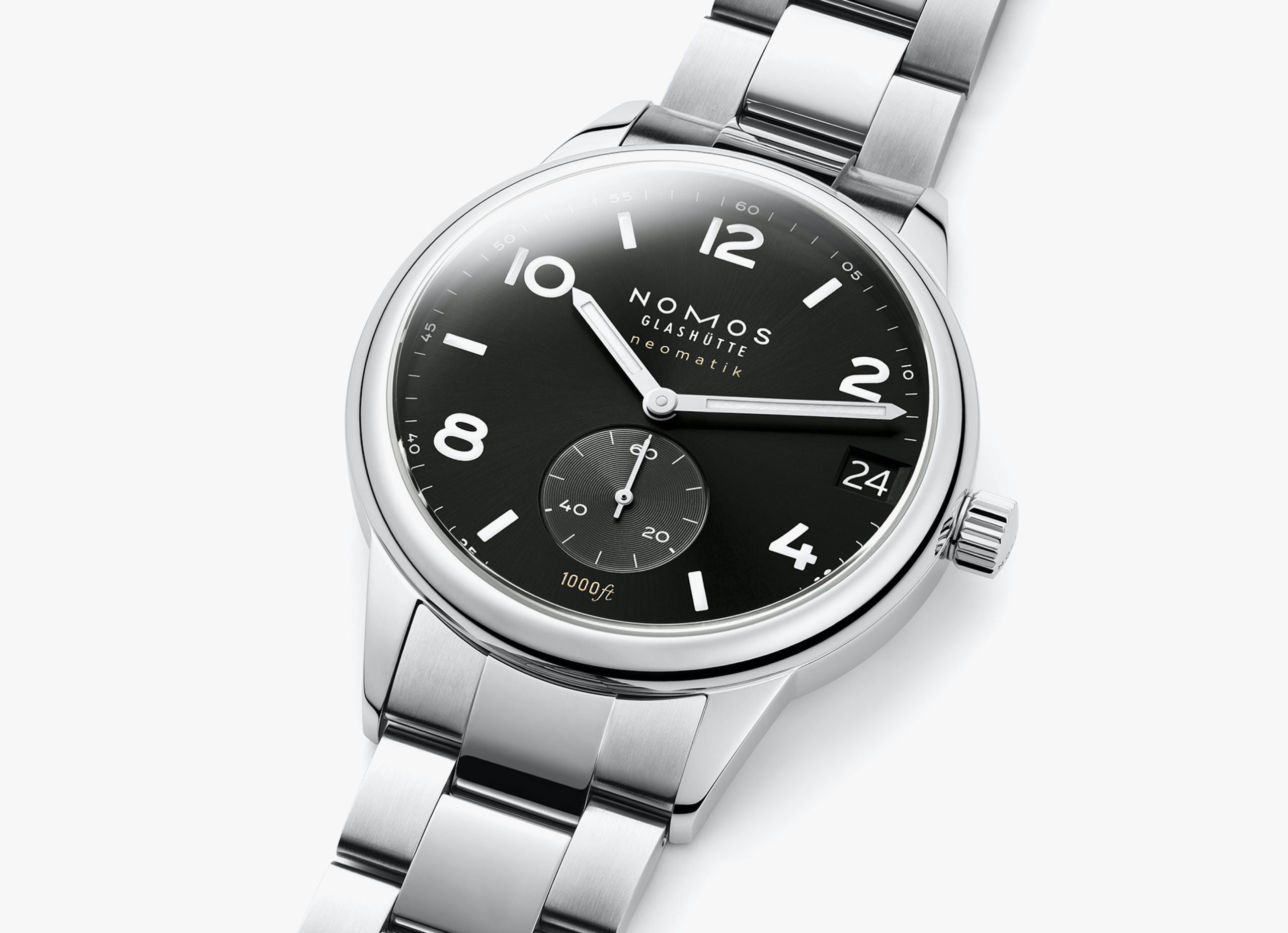Nomos wristwatch with a black dial, silver-tone stainless steel case and bracelet, shown on a light gray background.