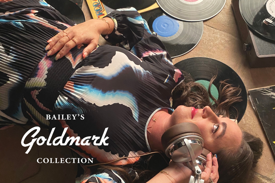 Person lying on a record with 'Bailey's Goldmark Collection' text overlay