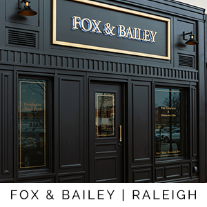 Black storefront with 'FOX & BAILEY' sign and text at the bottom.