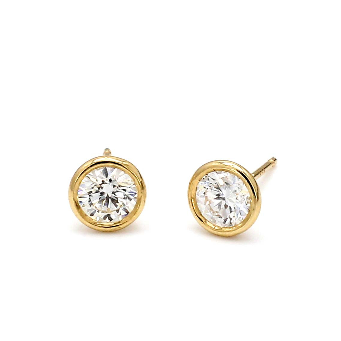 Pair of gold diamond stud earrings on white background