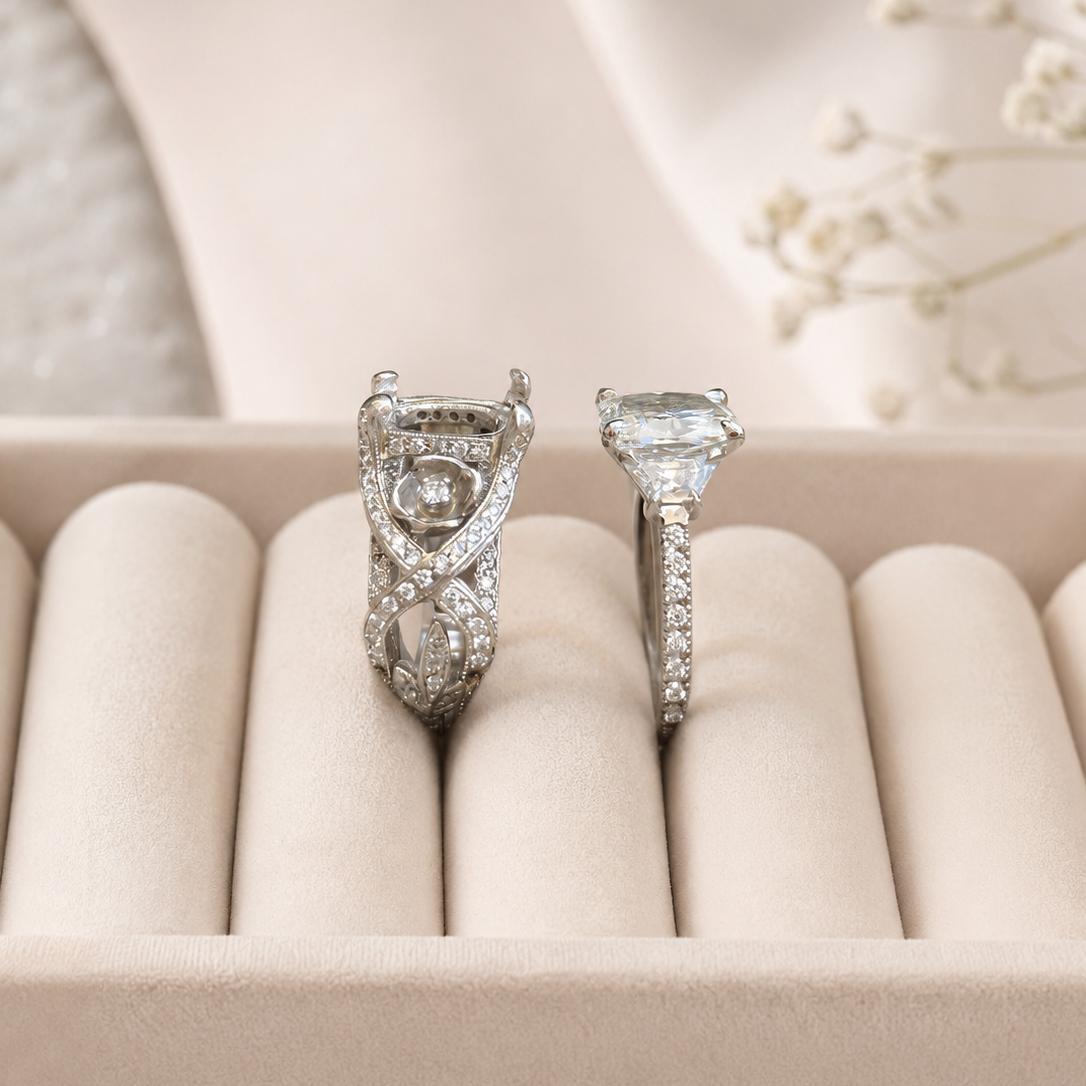 Two diamond rings in a jewelry box with a soft, neutral background.