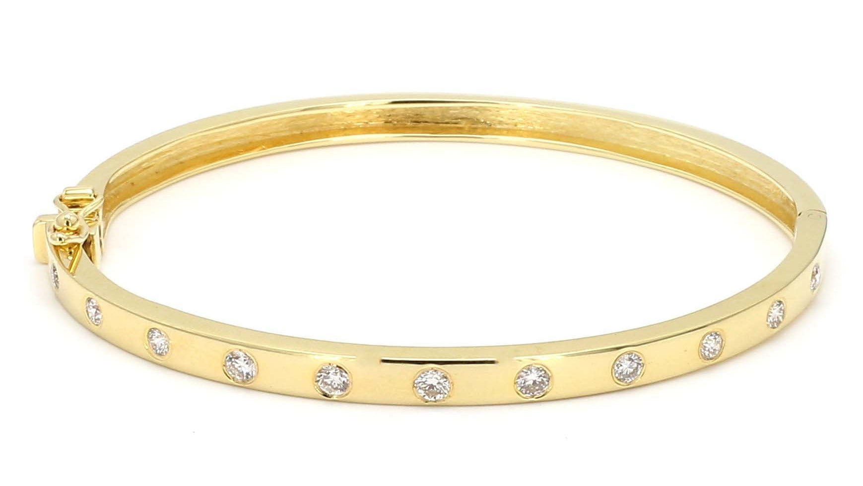 Gold bangle with small diamonds on a white background