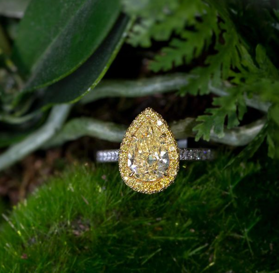 yellow diamond ring with green leafy background