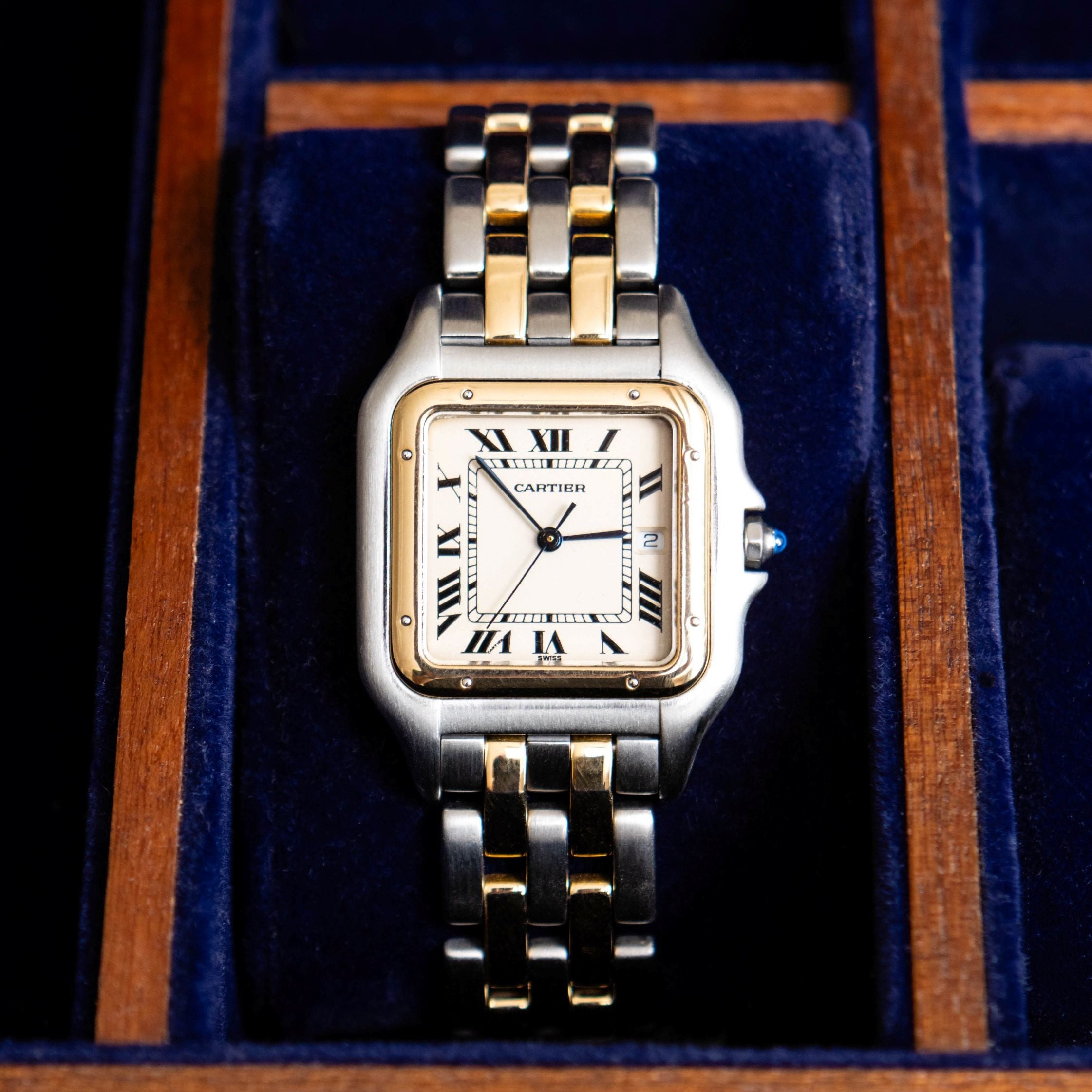 Luxury watch with two-tone band in a wooden and blue velvet box