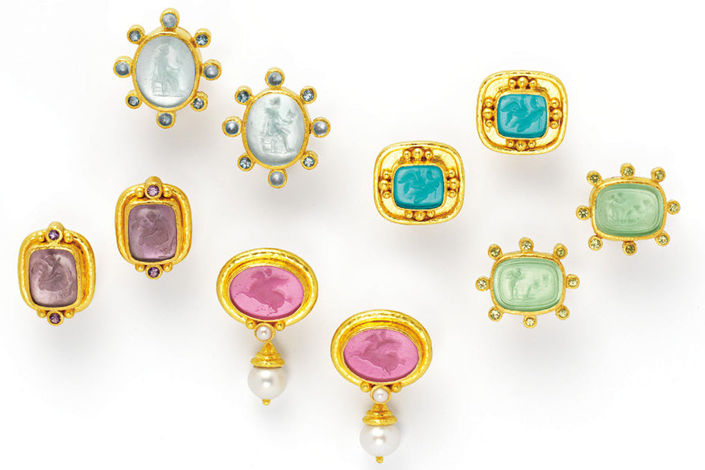 Set of colorful gemstone earrings with gold settings on a white background