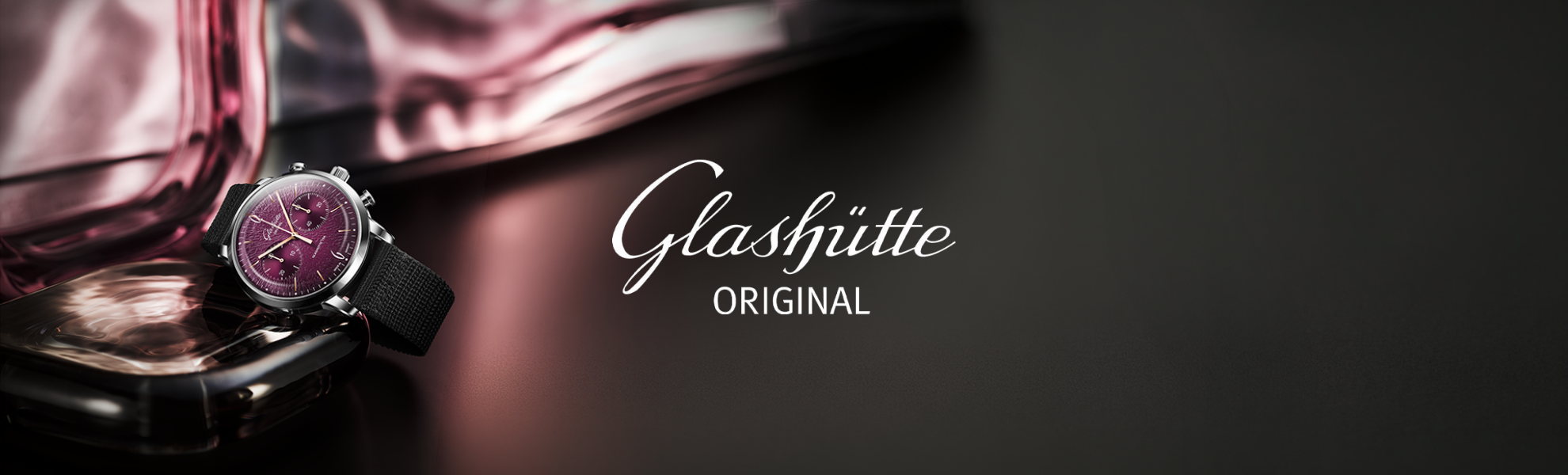 Glashütte watch with pink gemstone on a dark background