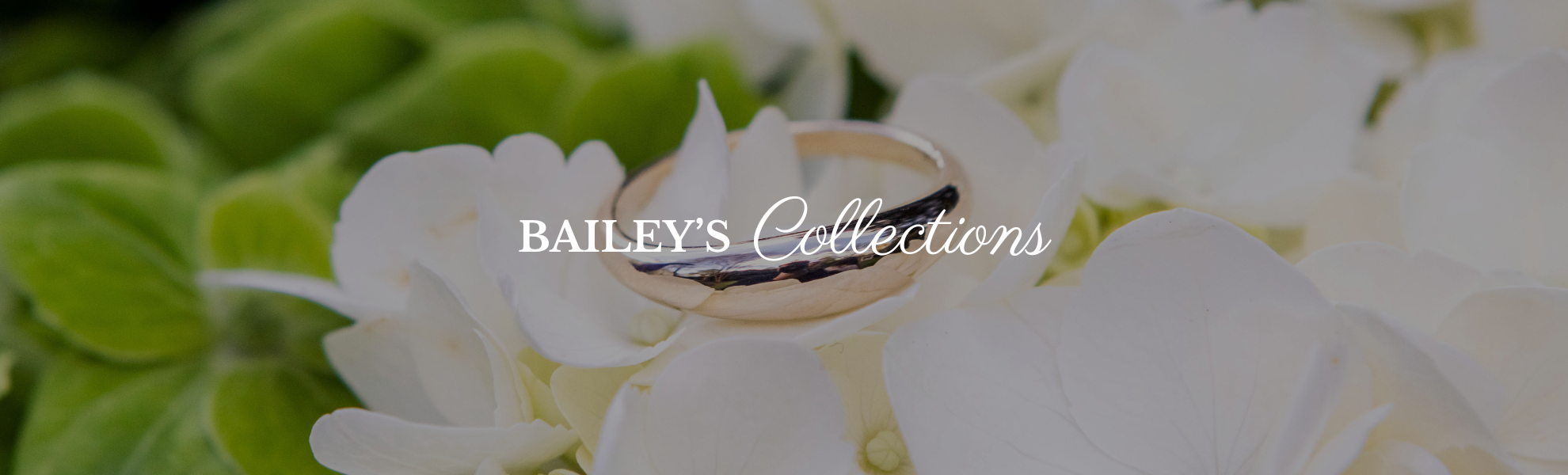 Gold ring on white flowers with 'Baileys Collections' text