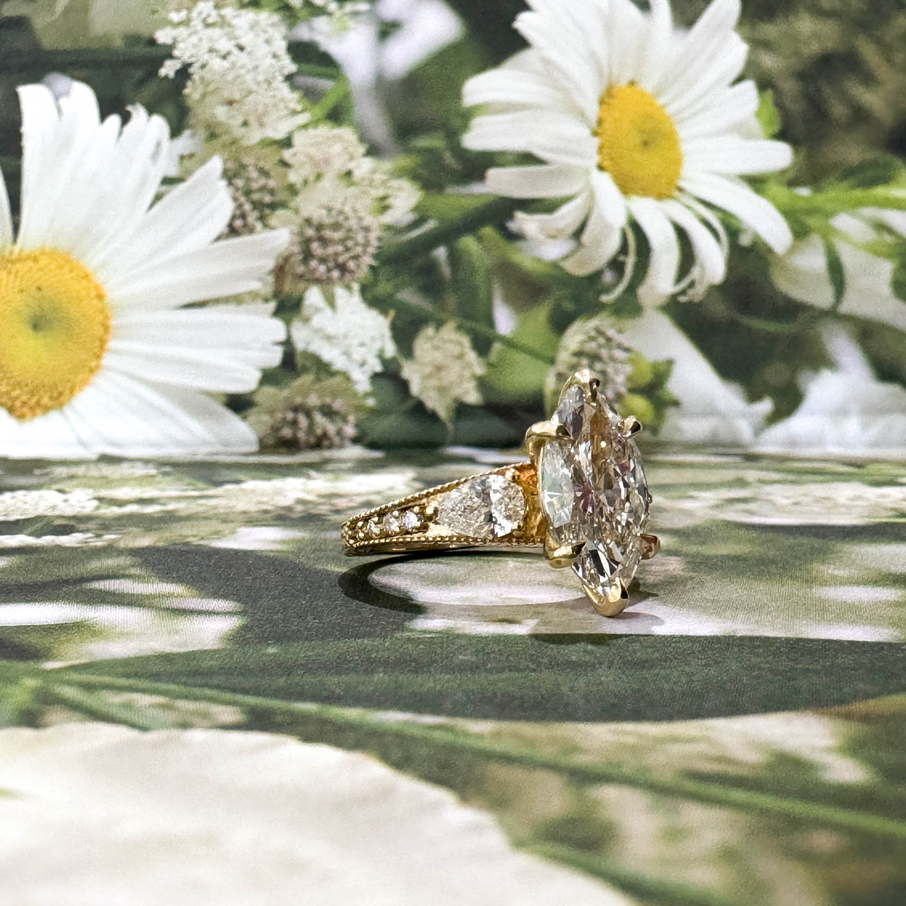 Gold ring with a large diamond surrounded by white flowers