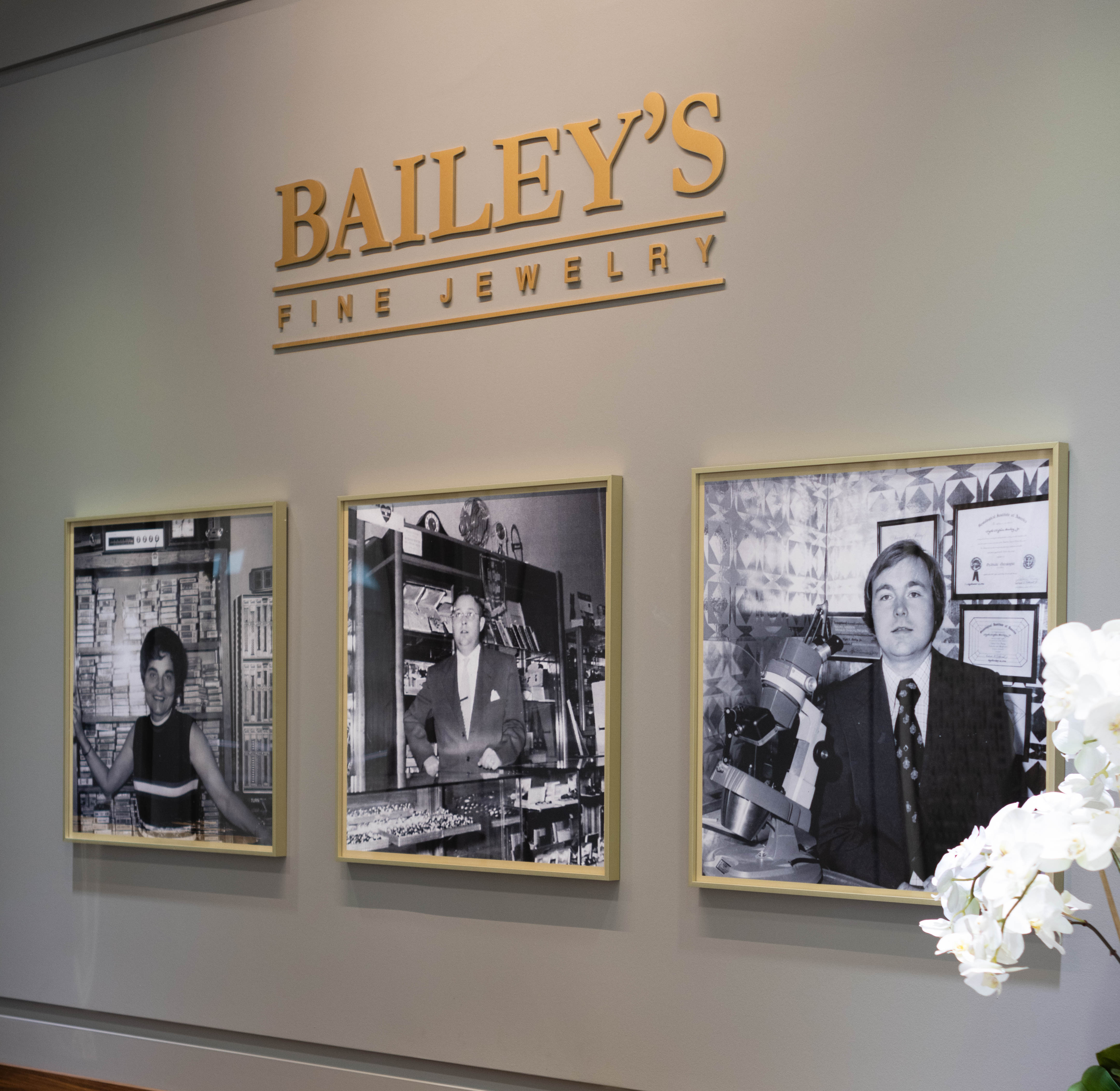 Bailey's Fine Jewelry display with framed black and white photos on a wall.