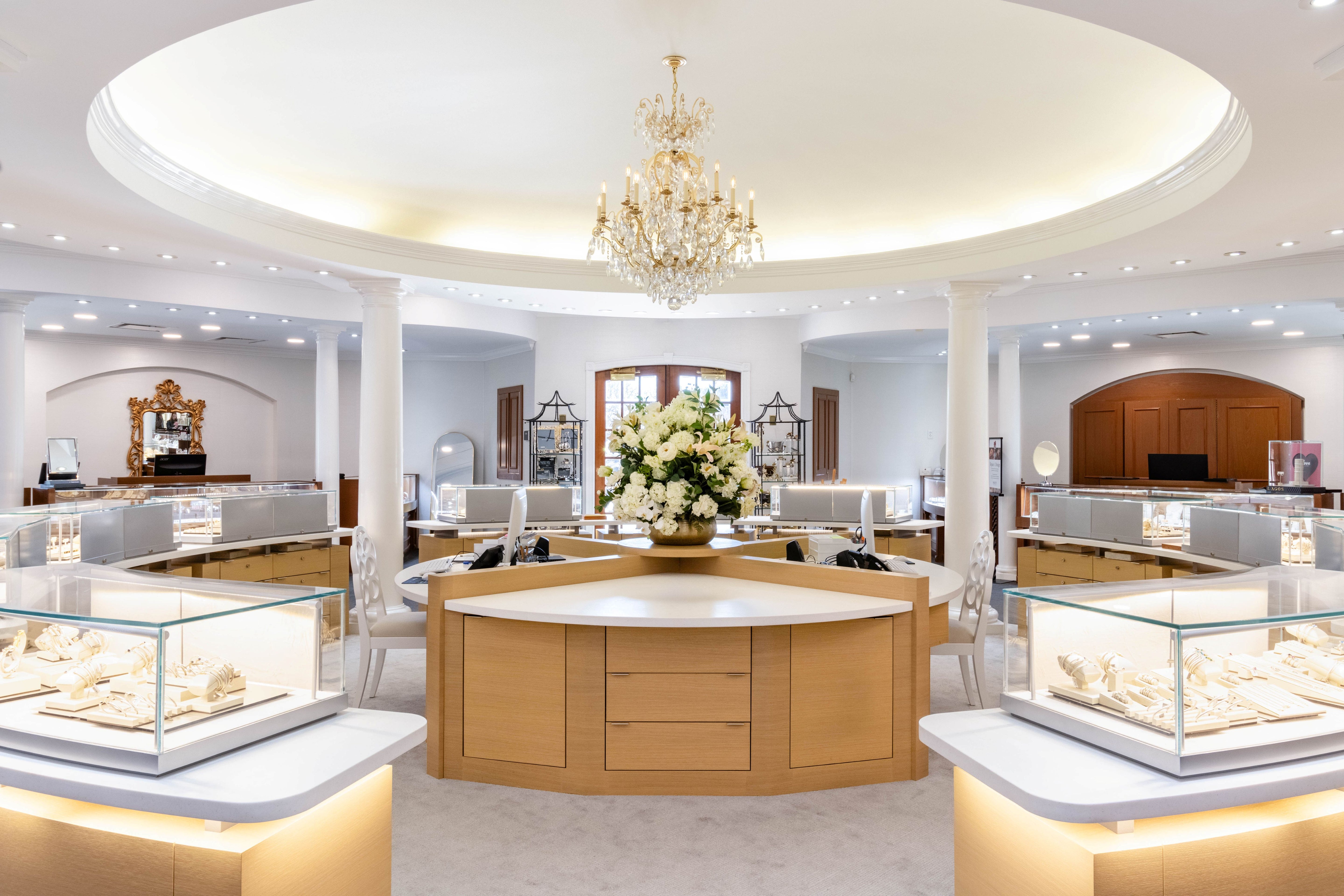 Jewelry store interior with display cases and a chandelier.
