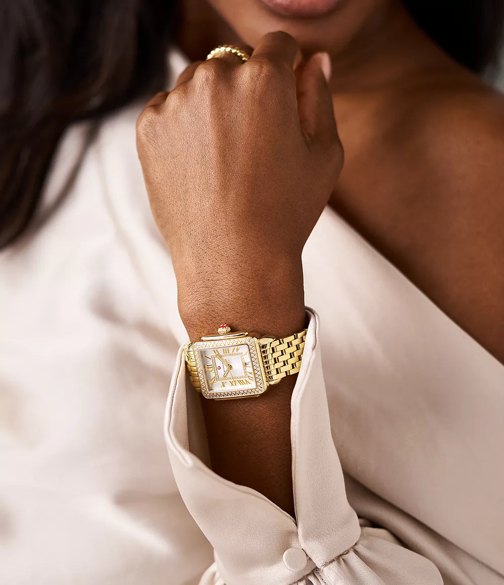 close up of watch on woman's wrist with a neutral background
