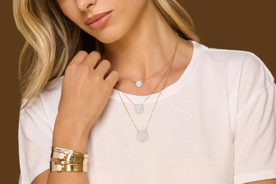 Woman wearing gold jewelry on a brown background