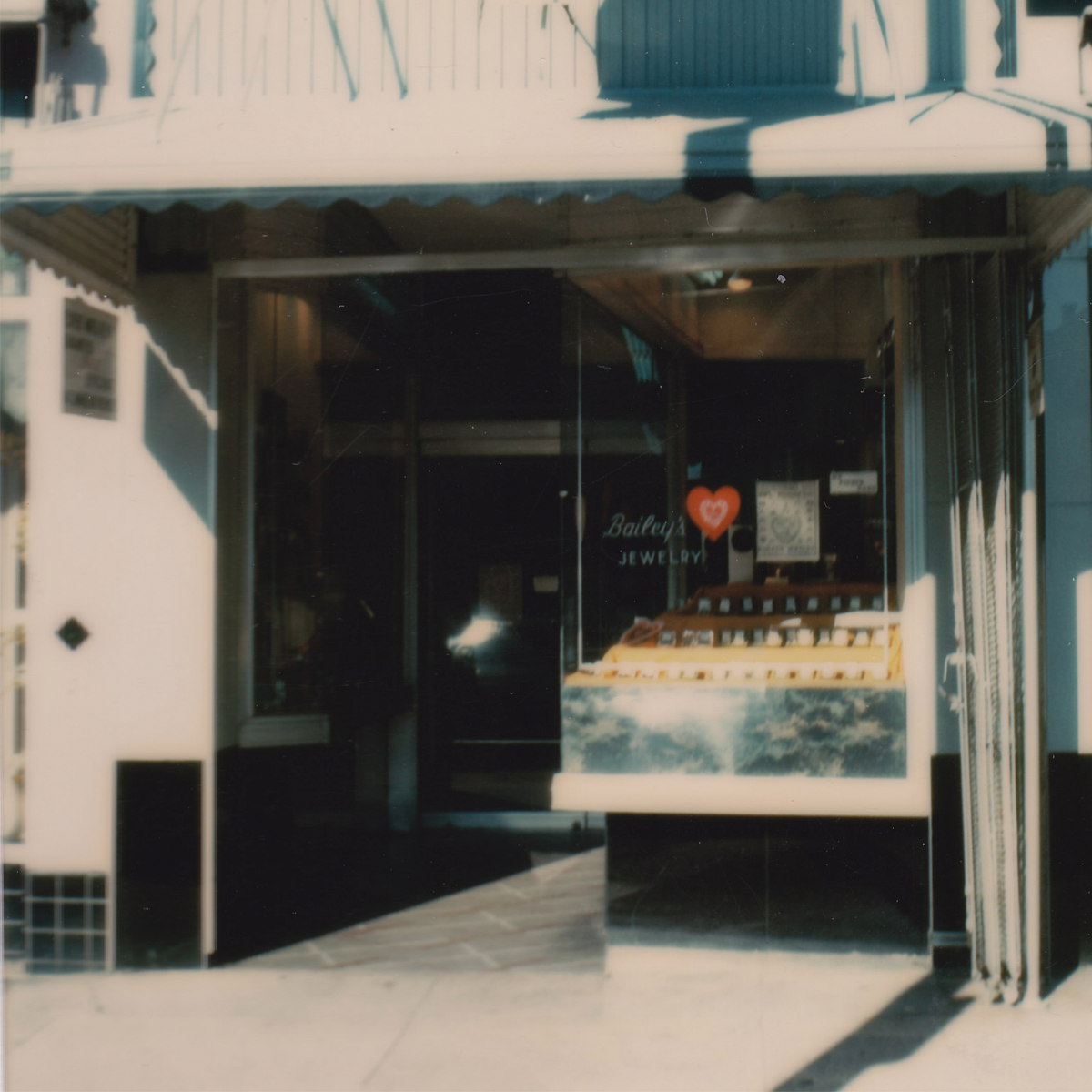 Storefront with jewelry display case on a sunny day