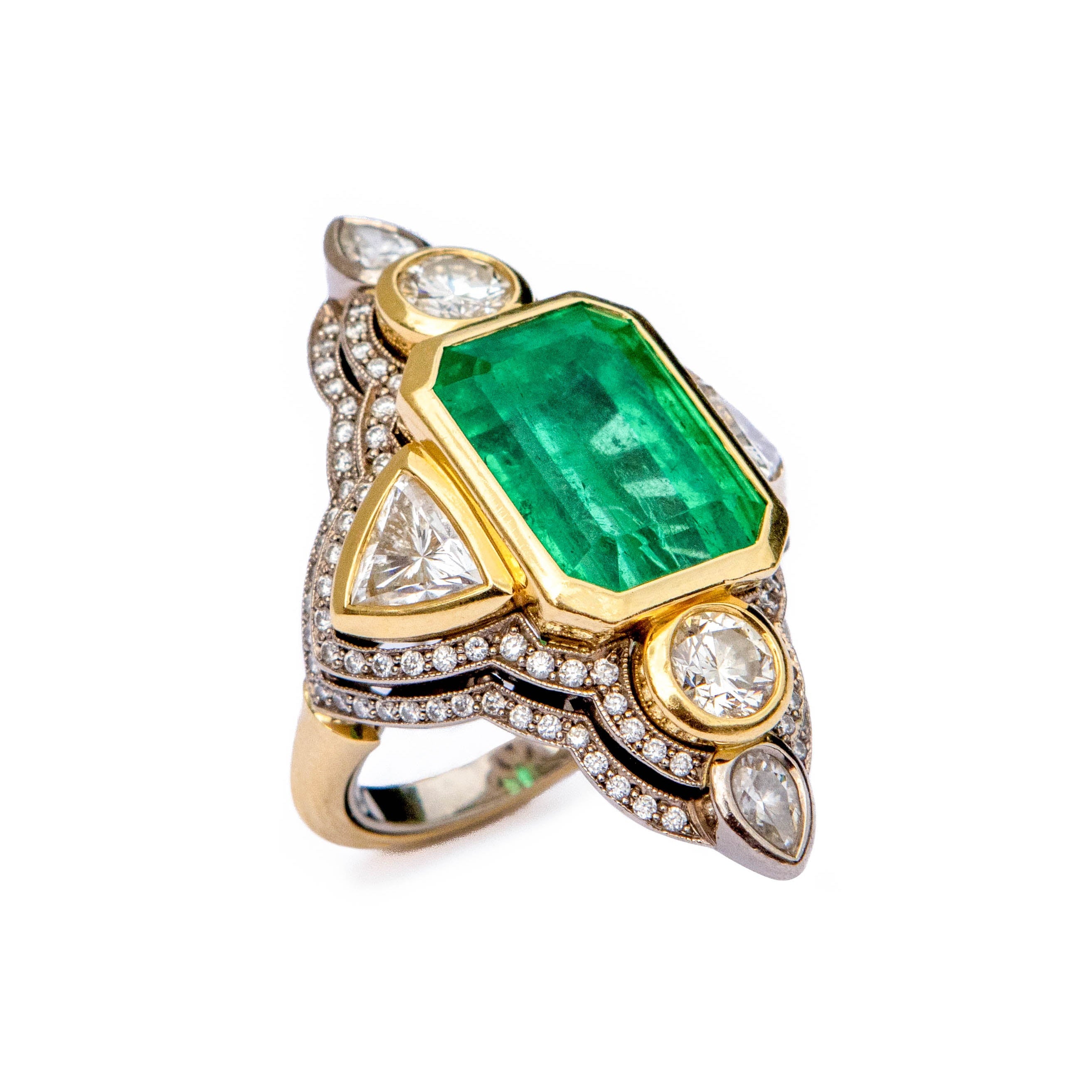 Gold ring with a green gemstone and diamonds on a white background