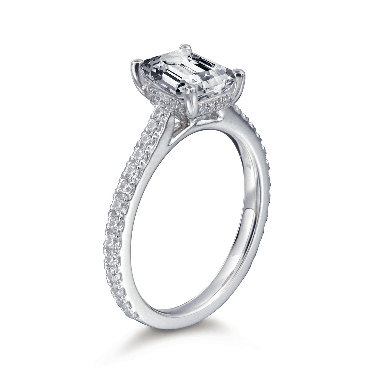 Diamond ring with a central emerald-cut diamond and smaller diamonds on the band against a white background
