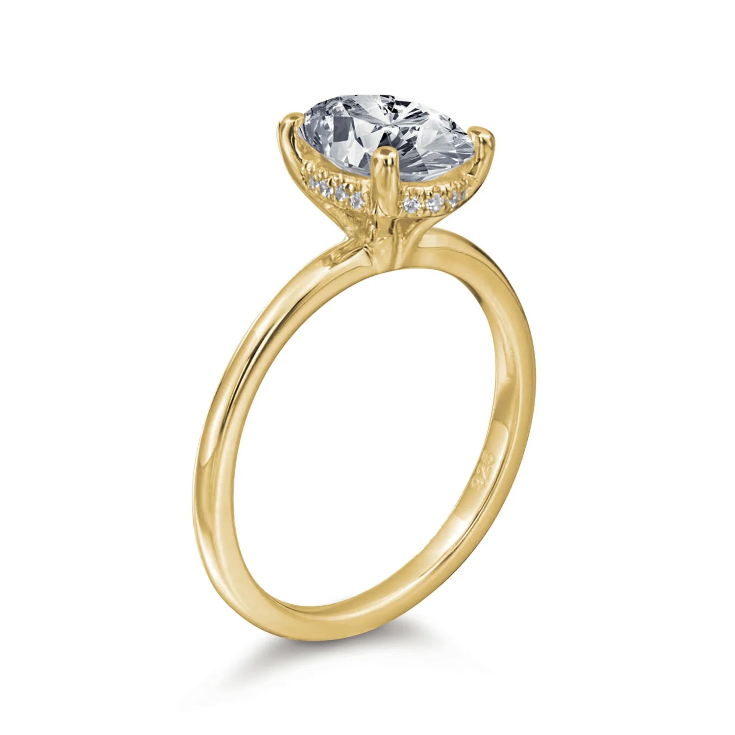 Gold ring with a large diamond and smaller diamonds on the band against a white background