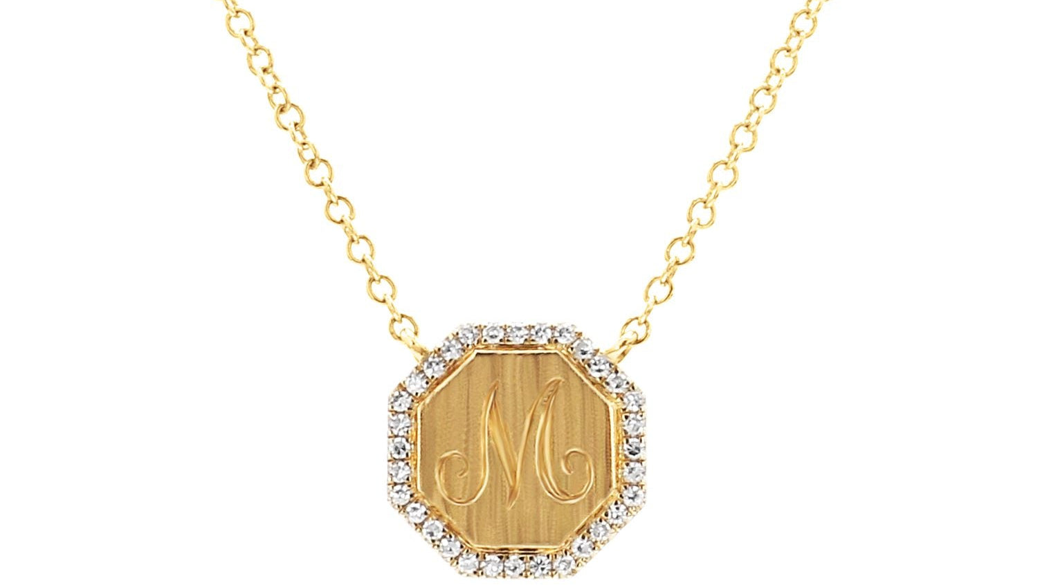 Gold necklace with a hexagonal pendant featuring initials on a white background