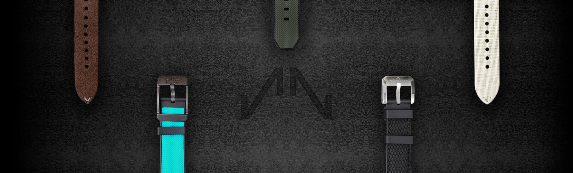 Collection of watch straps on a dark surface with a brand logo.