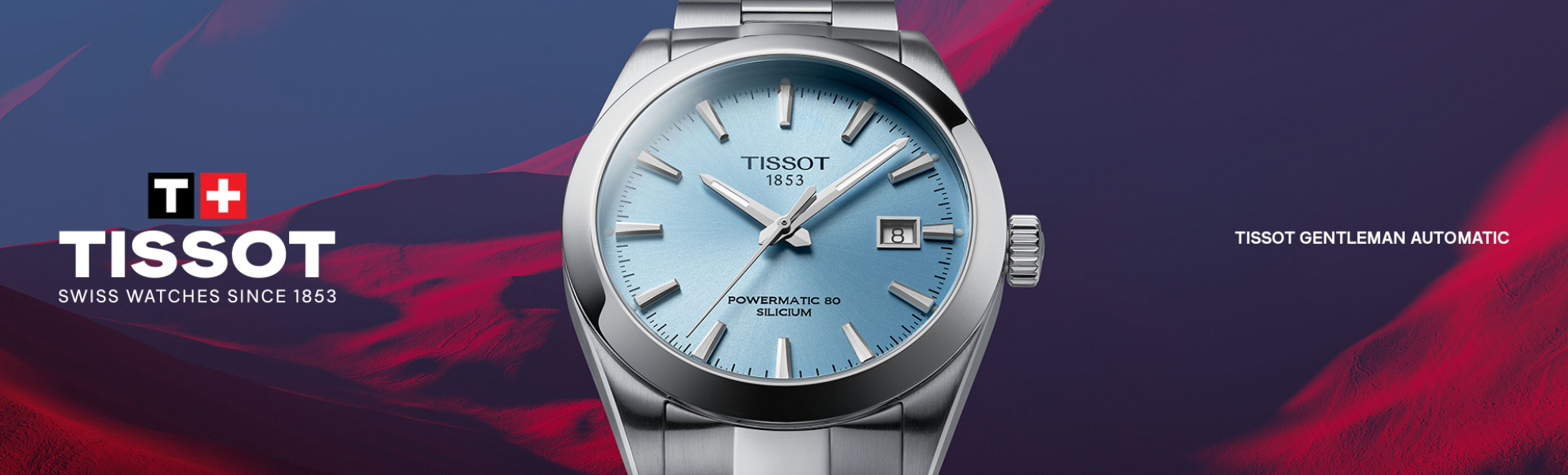 Tissot watch with blue face and silver case on a dark background