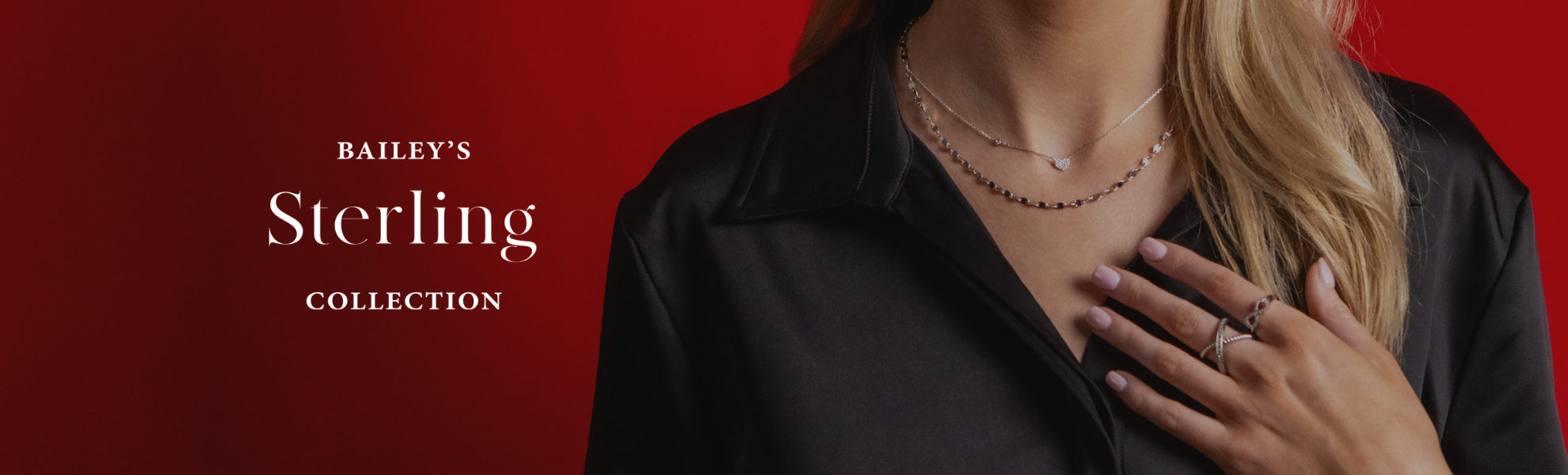 Person wearing a necklace with a red background and 'Bailey's Sterling Collection' text.