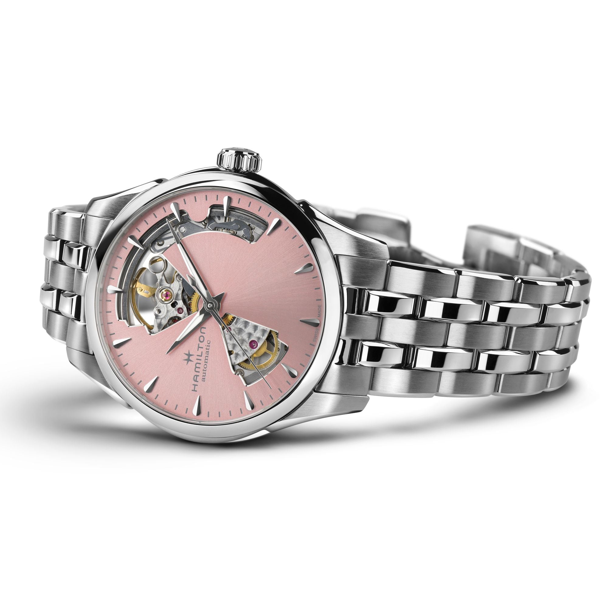A Hamilton watch with a polished silver-tone stainless steel case and link bracelet, featuring a light pink dial with an open-heart design showing the mechanical movement.