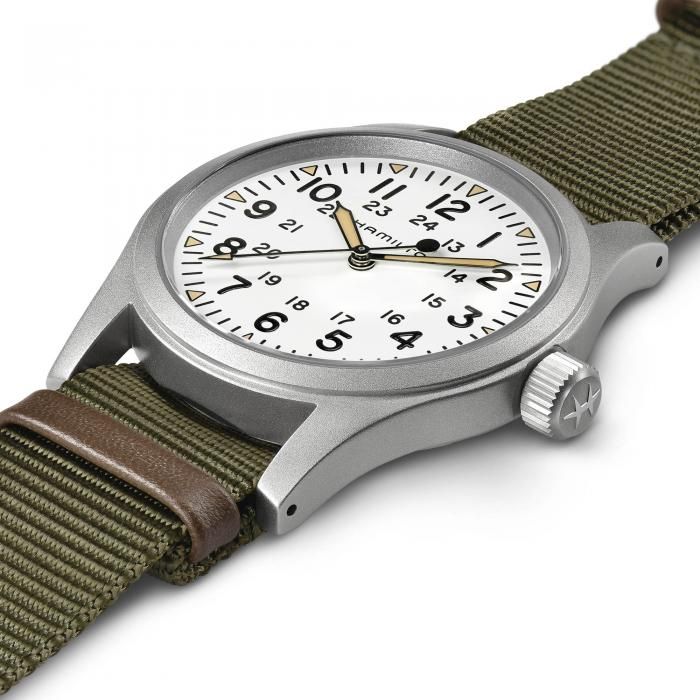 Wristwatch with green strap and silver case on a white background