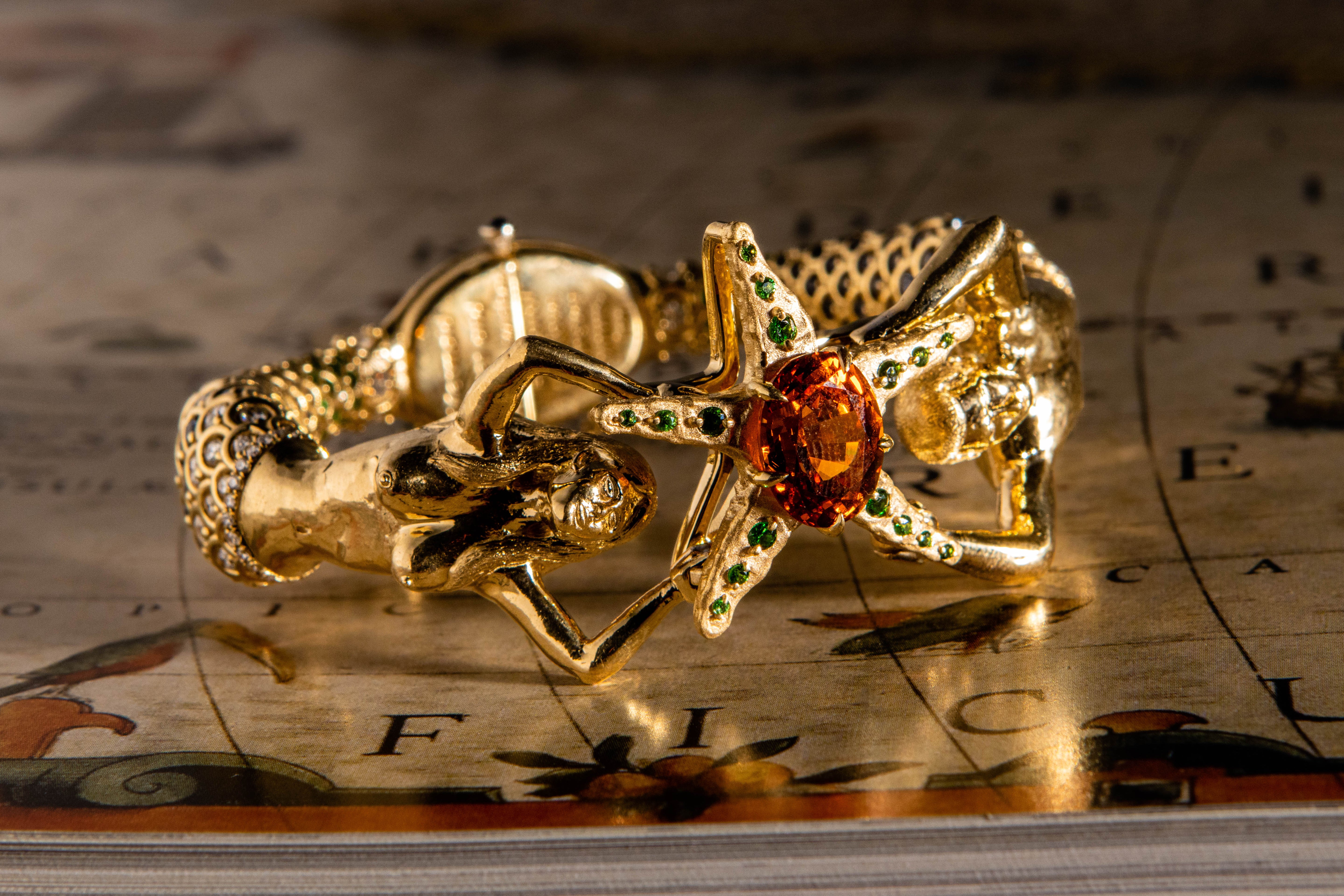 Gold starfish and mermaids custom bracelet with gemstones on a map background