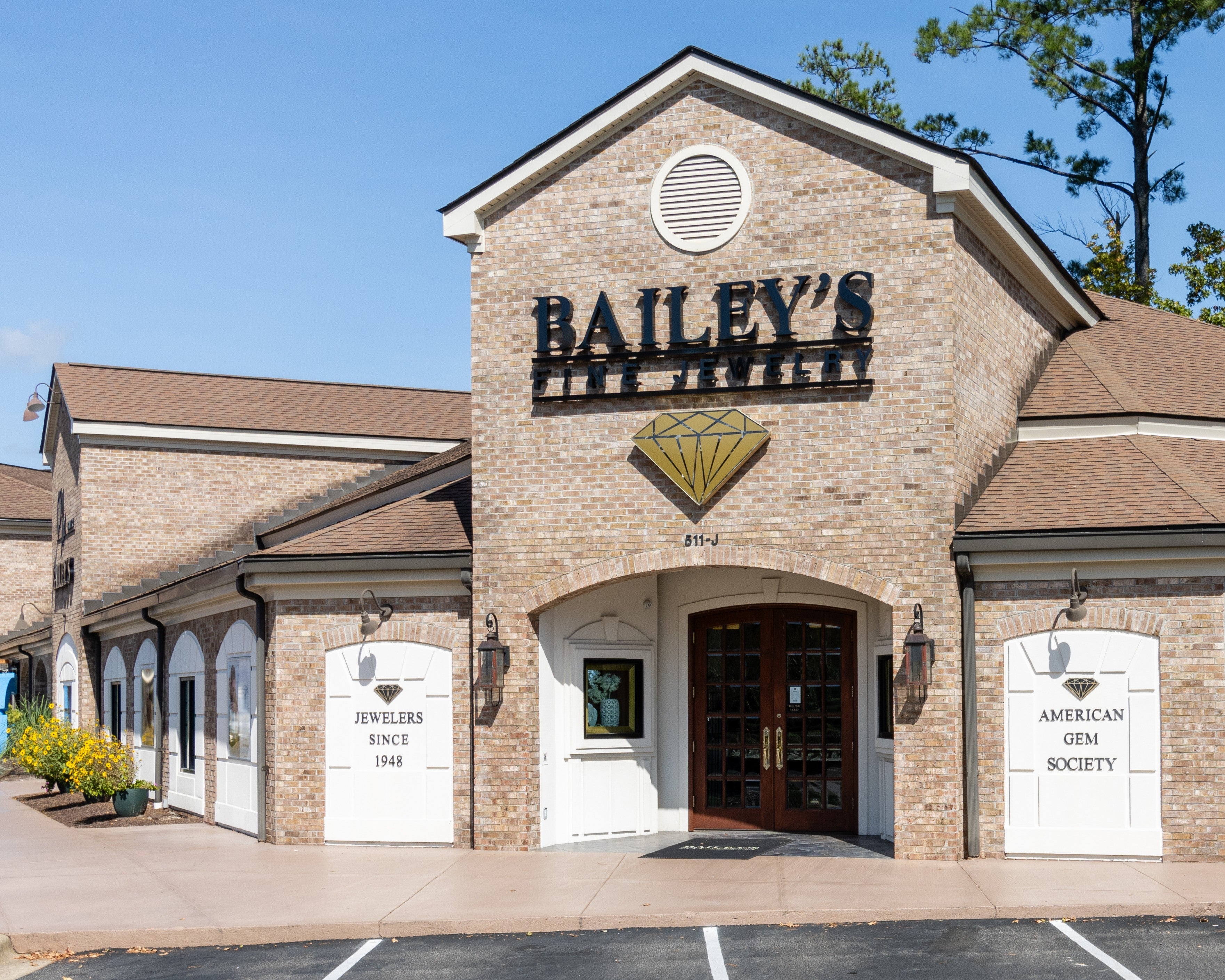 Bailey's Jewelers store front with a clear blue sky and trees in the background