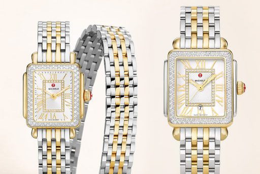 Two watches with two-tone metal straps on a light background