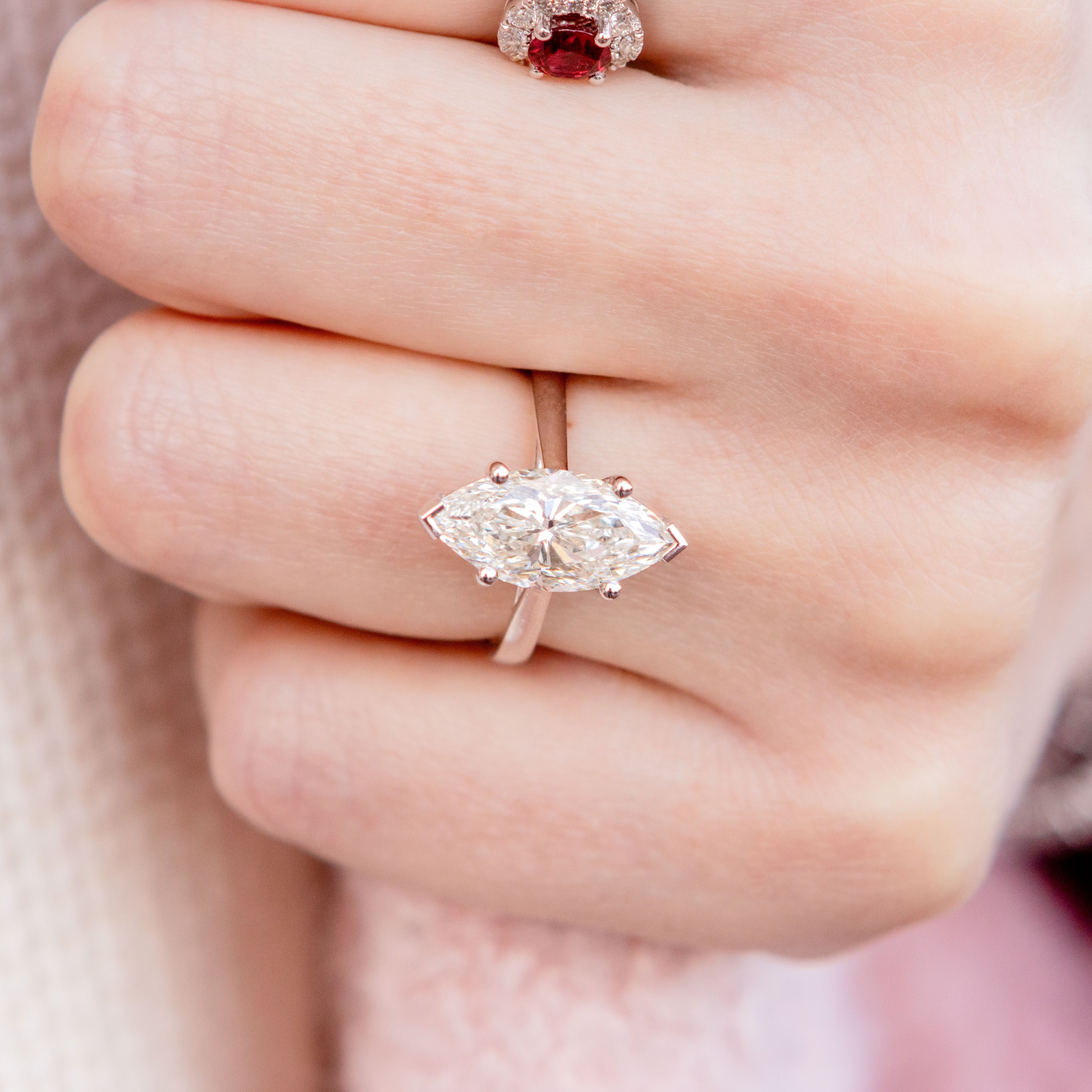 Marquise-cut diamond ring on a hand with a blurred background