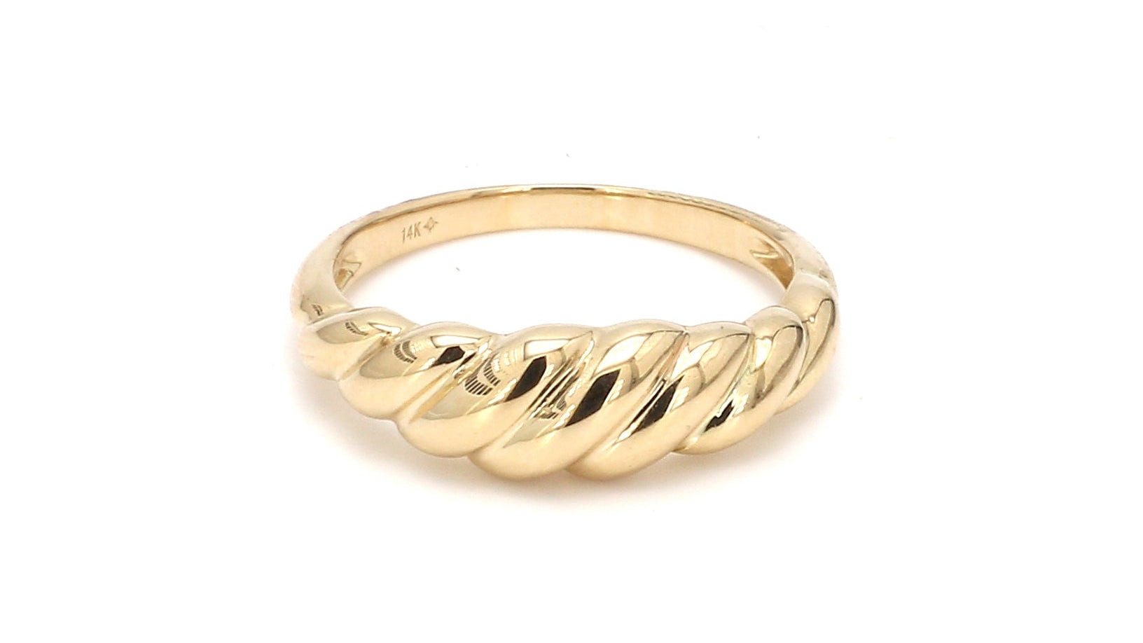 Gold ring with a ribbed design on a white background